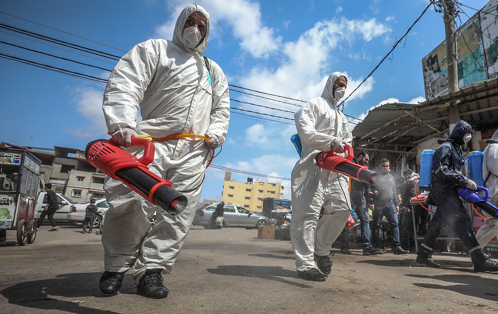 Health workers disinfect the streets in the Gaza Strip  ()