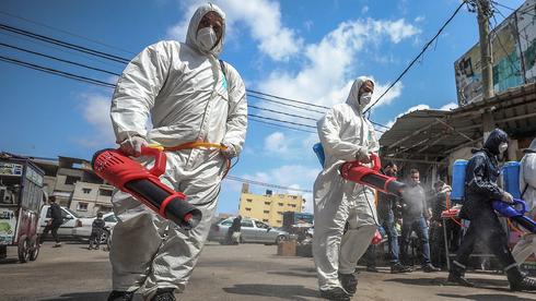  Hamas people sanitize the streets of Gaza amid virus fears  (Photo: EPA)