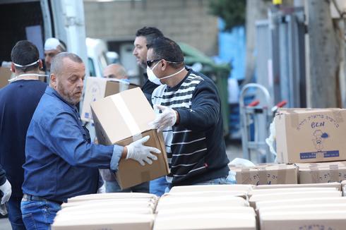 Delivering food to needy Israelis isolated at home due to coronavirus  (Photo: GPO)