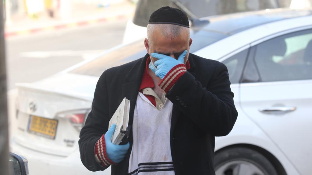A man wearing a gloves and mask in Bnei Brak  ()