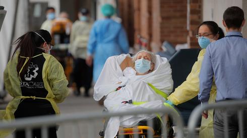  A suspected coronavirus patient being taken to hospital in New York  (Photo: Reuters)