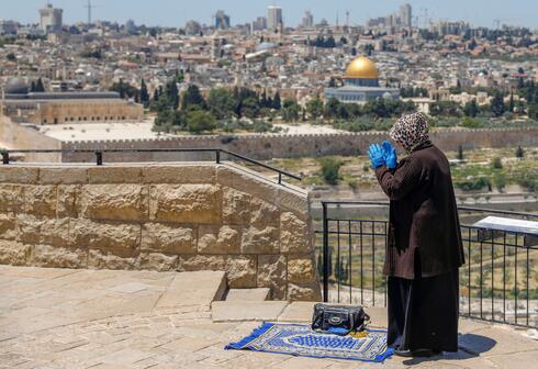 Woman praying in East Jerusalem during Ramadan 