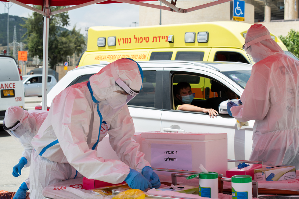 Health officials man a pop-up testing site at the Teddy Stadium in Jerusalem  ()
