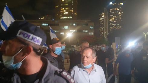 Amnon Abramovich is escorted from a right-wing protest in Tel Aviv  (Photo: Courtesy)