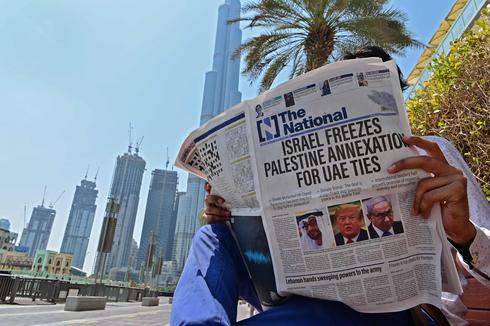 A man in Dubai reads a local newspaper reporting on the Israel-UAE peace deal (Photo: AFP) A man in Dubai reads a local newspaper reporting on the Israel-UAE peace deal