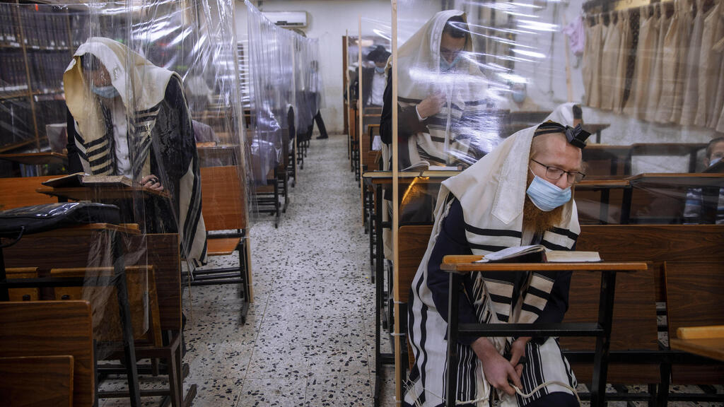In this Monday, Sept 21, 2020 file photo, ultra-Orthodox Jews wear face masks during a morning prayer in a synagogue separated by plastic partitions, in Bnei Brak (Photo: AP) In this Monday, Sept 21, 2020 file photo, ultra-Orthodox Jews wear face masks during a morning prayer in a synagogue separated by plastic partitions, in Bnei Brak