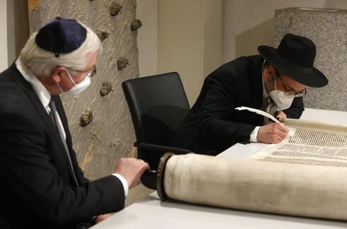 German President Frank-Walter Steinmeier, right, and Rabbi Shaul Nekrich, right, take part in a ceremony at the Reichstag building to complete the historic Sulzbach Torah Scroll from 1792 (Photo: AP) German President Frank-Walter Steinmeier, right, and Rabbi Shaul Nekrich, right, take part in a ceremony at the Reichstag building in Berlin, Germany, Wednesday, Jan. 27, 2021 to complete the historic Sulzbach Torah Scroll from 1792, rediscovered in 2013 and just restored. The ceremony takes place on the International Holocaust Remembrance Day
