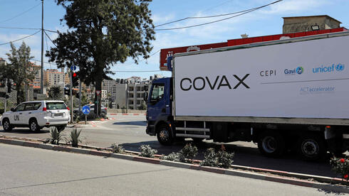 A refrigerated truck loaded with the first delivery of coronavirus vaccine via the United Nations Covax program that supports poorer areas will drive to the West Bank city of Ramallah on March 17, 2021. 