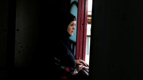 Niveen Gharqoud looks out from her home in the middle of the Gaza Strip 15 March 2021. Photo taken 15 March 2021 