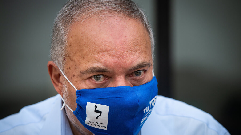 Avigdor Lieberman and his wife vote at the ballot box