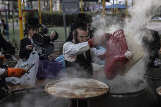 An ultra-Orthodox man dips in front of the Passover in Ashdod before the holiday begins on Saturday 