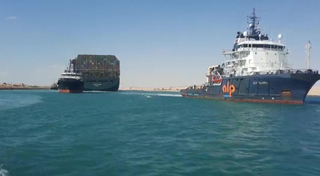 Tugboats pull the MV 'Ever Given' container ship with the Panama flag after being completely discharged from the shores of the Suez Canal 