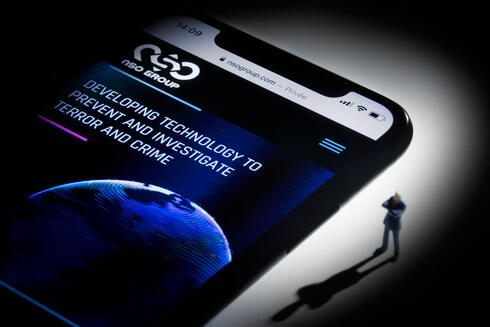 This studio photographic illustration shows a smartphone with the website of Israel's NSO Group which features 'Pegasus' spyware, on display in Paris on July 21, 2021 