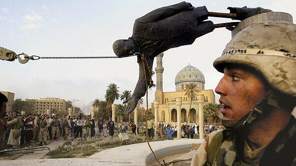 Iraqi civilians and U.S. soldiers pull down a statue of Saddam Hussein in downtown Baghdad, in this April 9, 2003