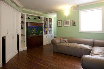 חדר המשפחה נצבע בירוק, ובו ספה פינתית בעיצוב אריק בן שמחון (צילום: גידי בועז)